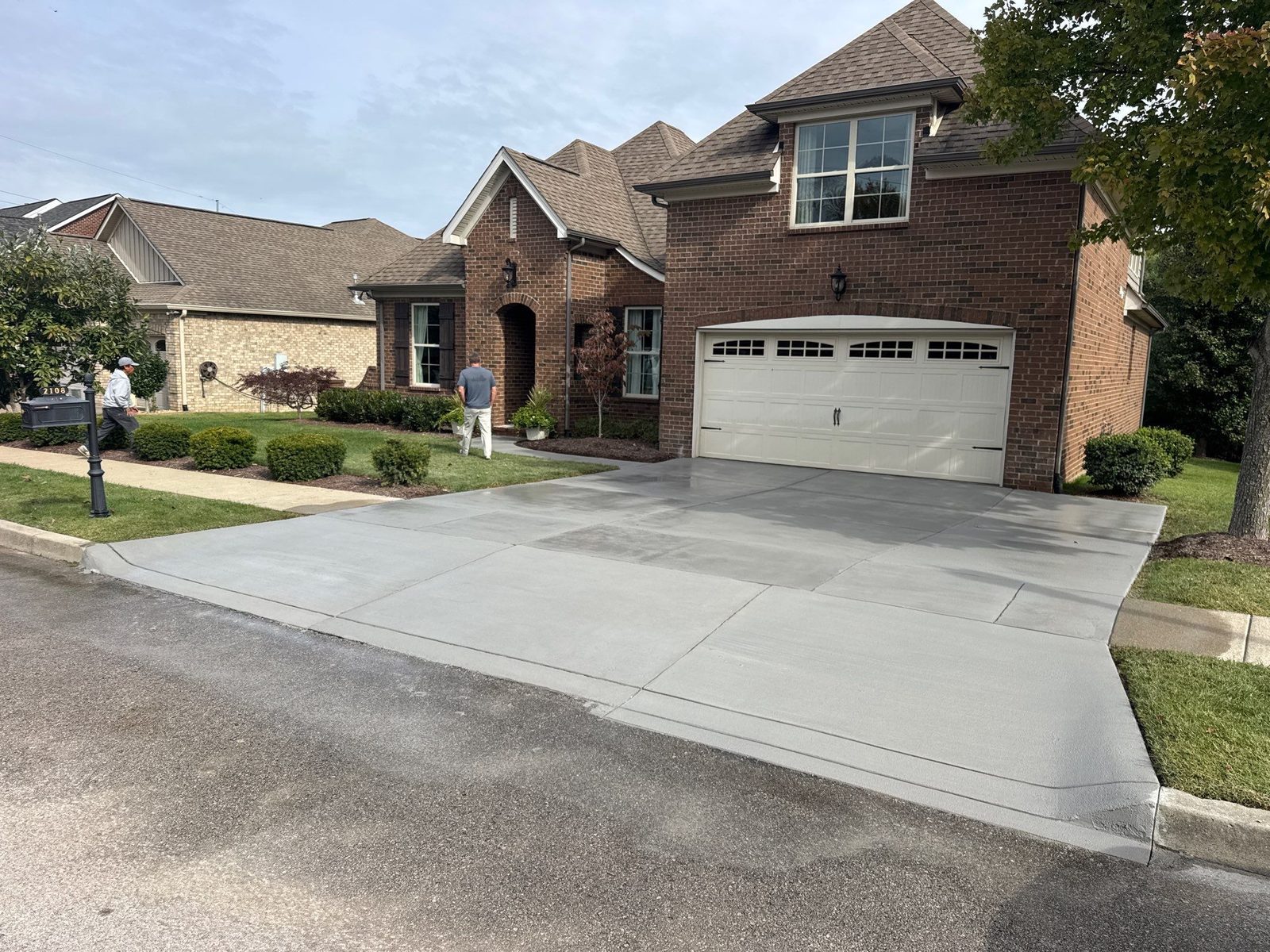 Resurfaced driveway in Westhaven with a clean broom finish in front of a brick home